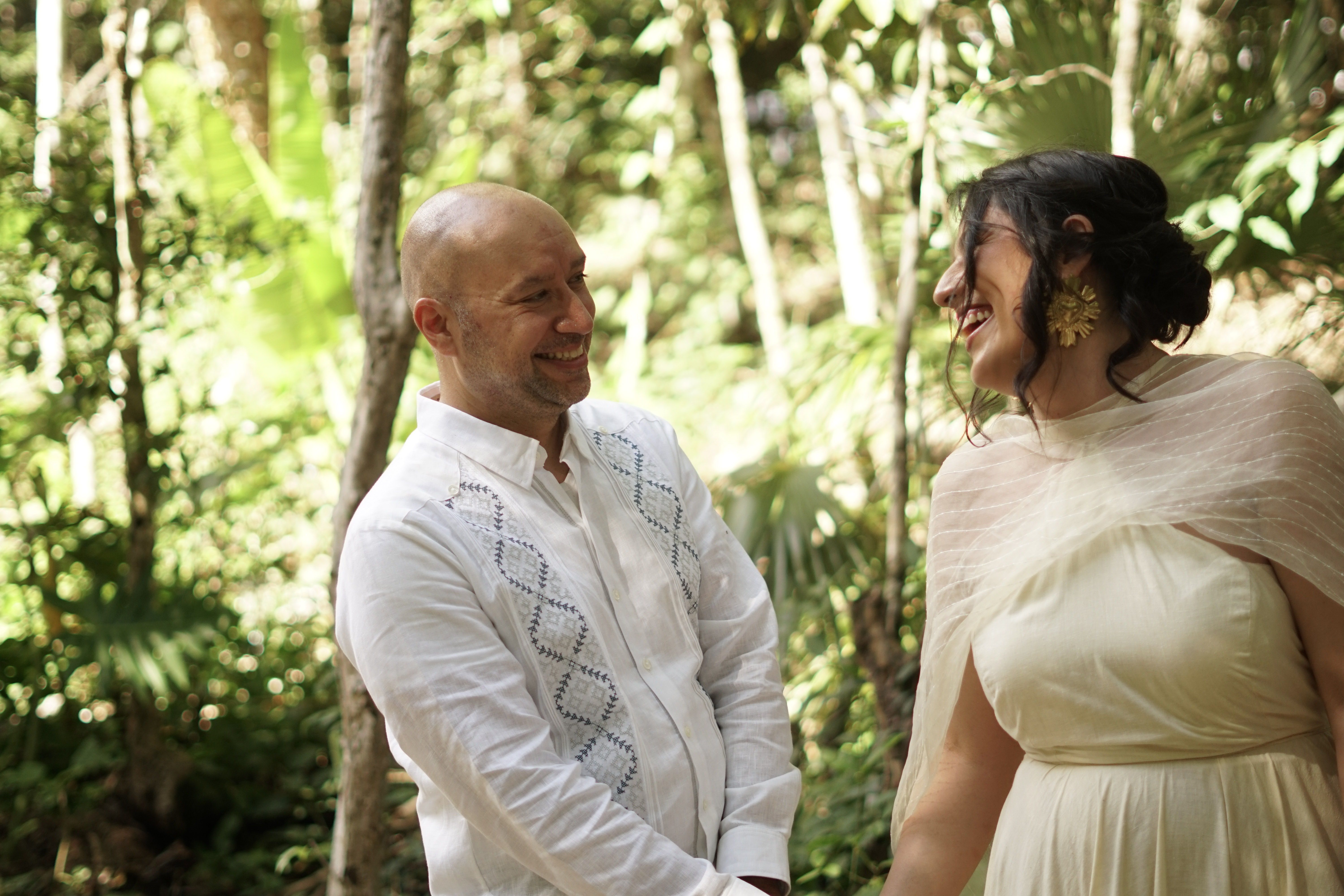 Bride and groom walking hand in hand along the jungle path at Casa Arkaana