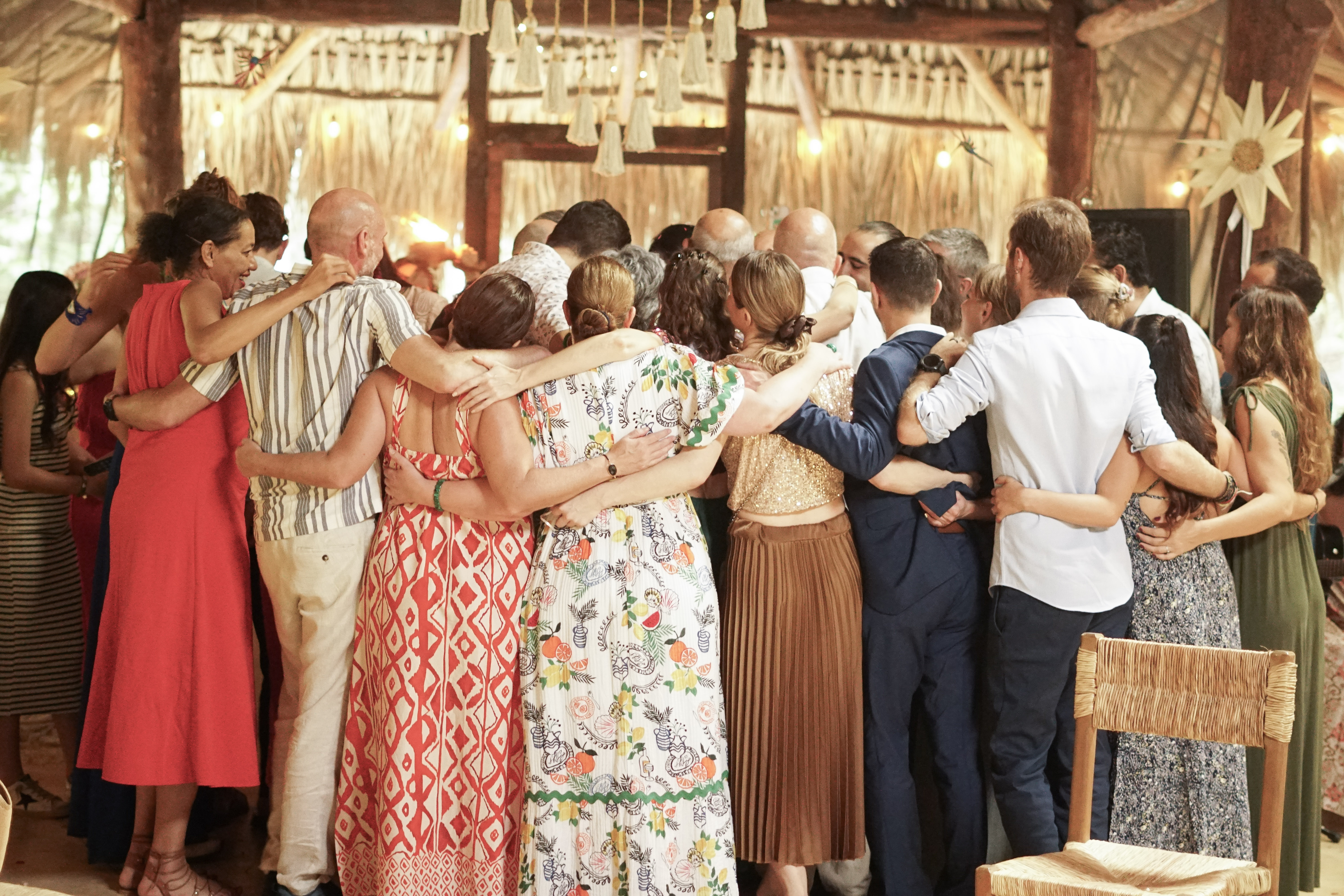 The whole tribe in a group embrace inside the temple at the end of the ceremony