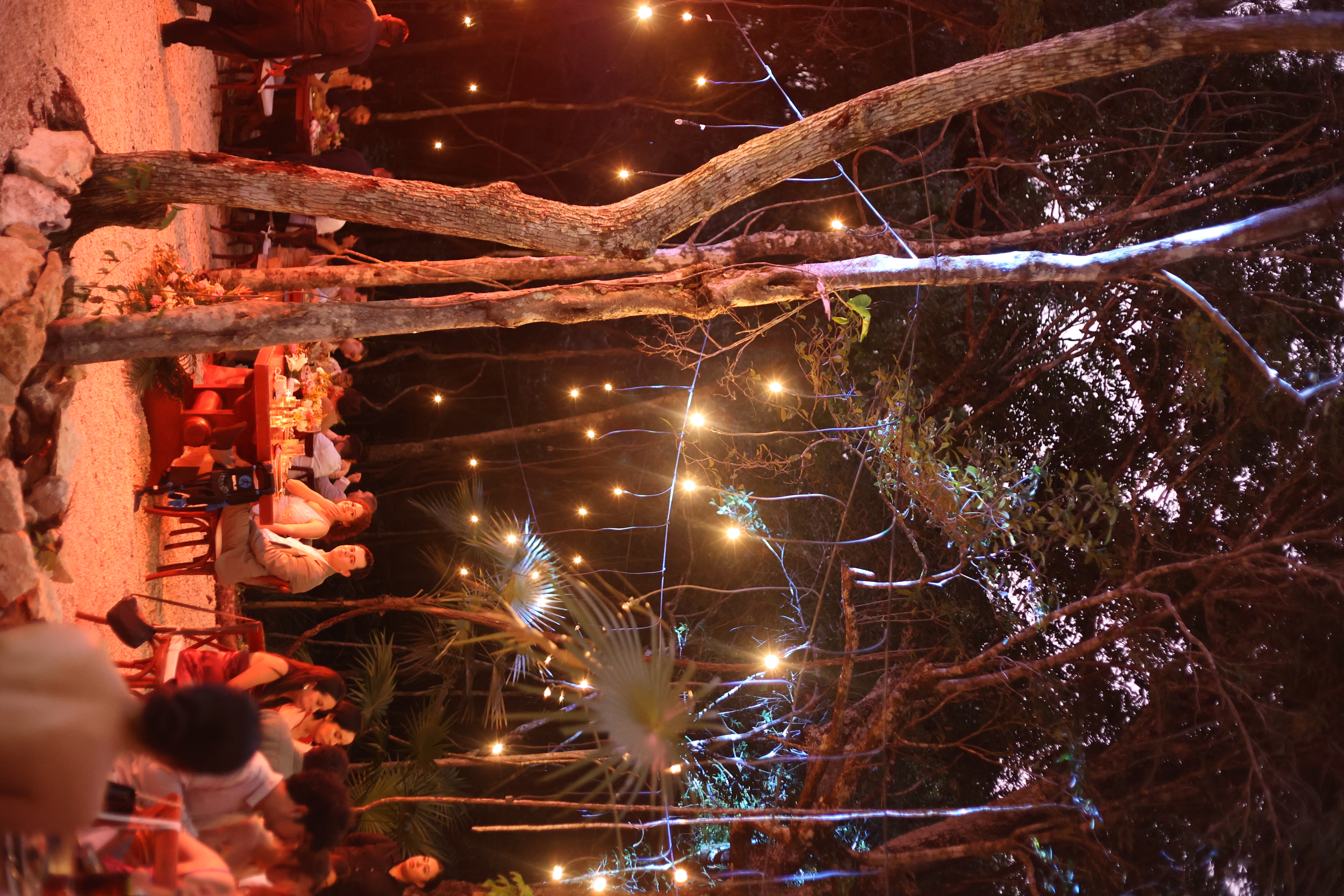 Wedding dinner under string lights deep in the Tulum jungle